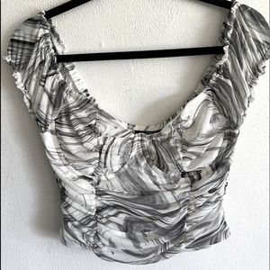 White and grey marble crop top with cleavage underwire .